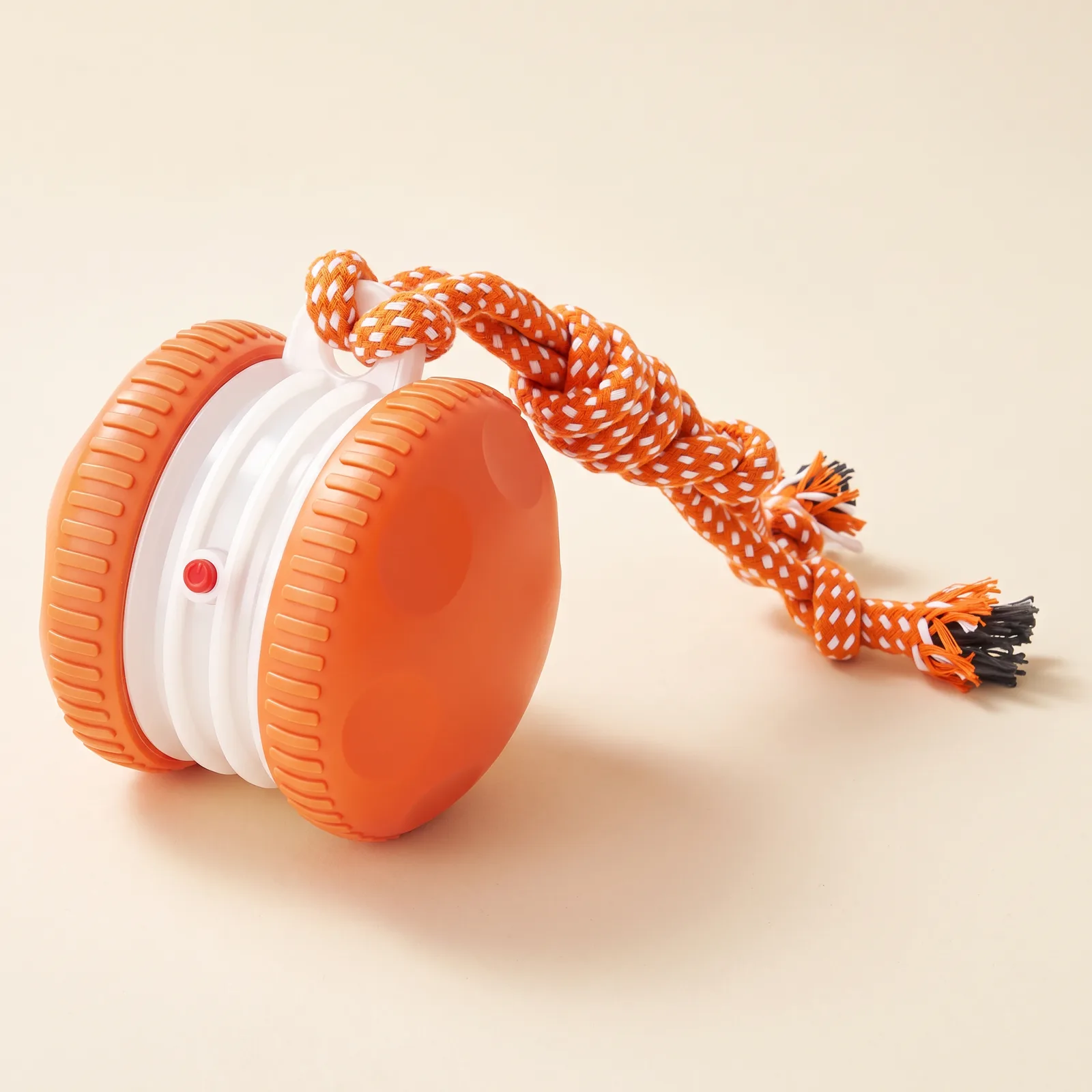 Orange rolling ball with orange and white rope
